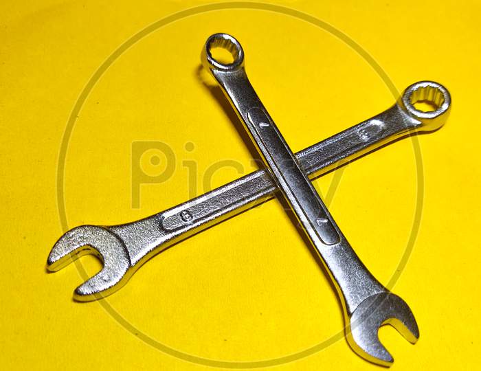 Wrench on the yellow background. working tool