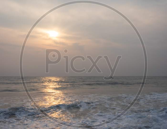Sunrise On Sea Beach With Waves