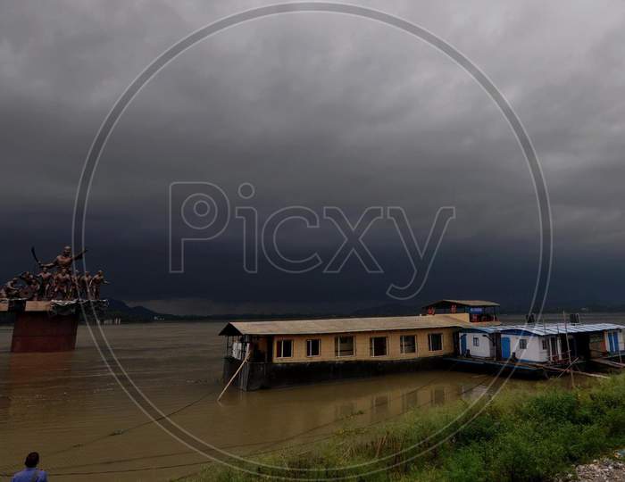 Dark Cloud Loom Over The Statue Of Ahom Lieutenant Lachit Borphukan Erected Over The River Brahmaputra In Guwahati On May 25, 2020.