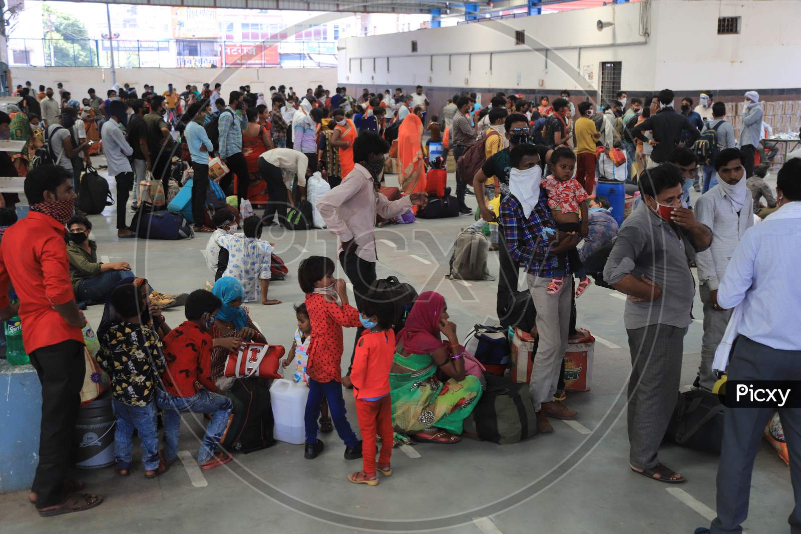 Migrants From Mumbai Arrived By A Special Train Wait To Board Buses To Their Native Villages During Extended Nationwide Lockdown Amidst Coronavirus Or COVID-19 Pandemic In Prayagraj, May 25, 2020.