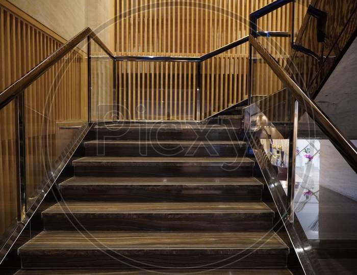Luxurious Staircase With Marble Steps And Decorative And Ornamental Iron And Glass Railings. Elegant Historical Stairs In A Luxury Interior Inside A Hotel.
