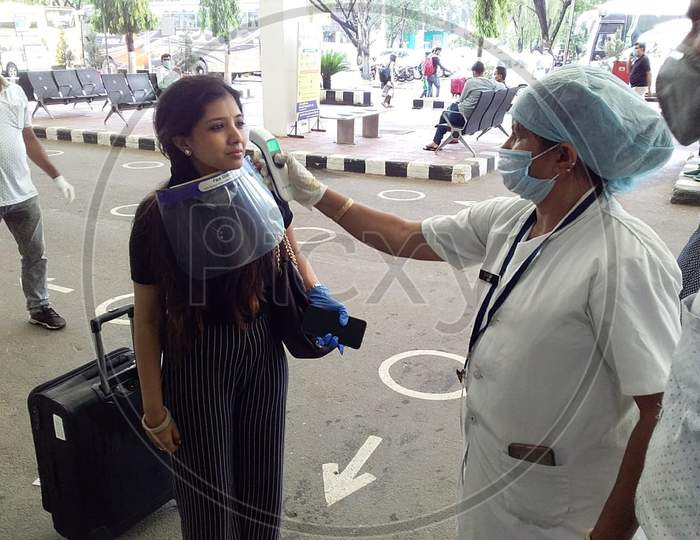 Passenger Gets Thermal Screening As She Arrives At Lokpriya Gopinath Bordoloi International Airport, Following The Resumption Of Domestic Flights, In Guwahati, Monday, May 25, 2020.