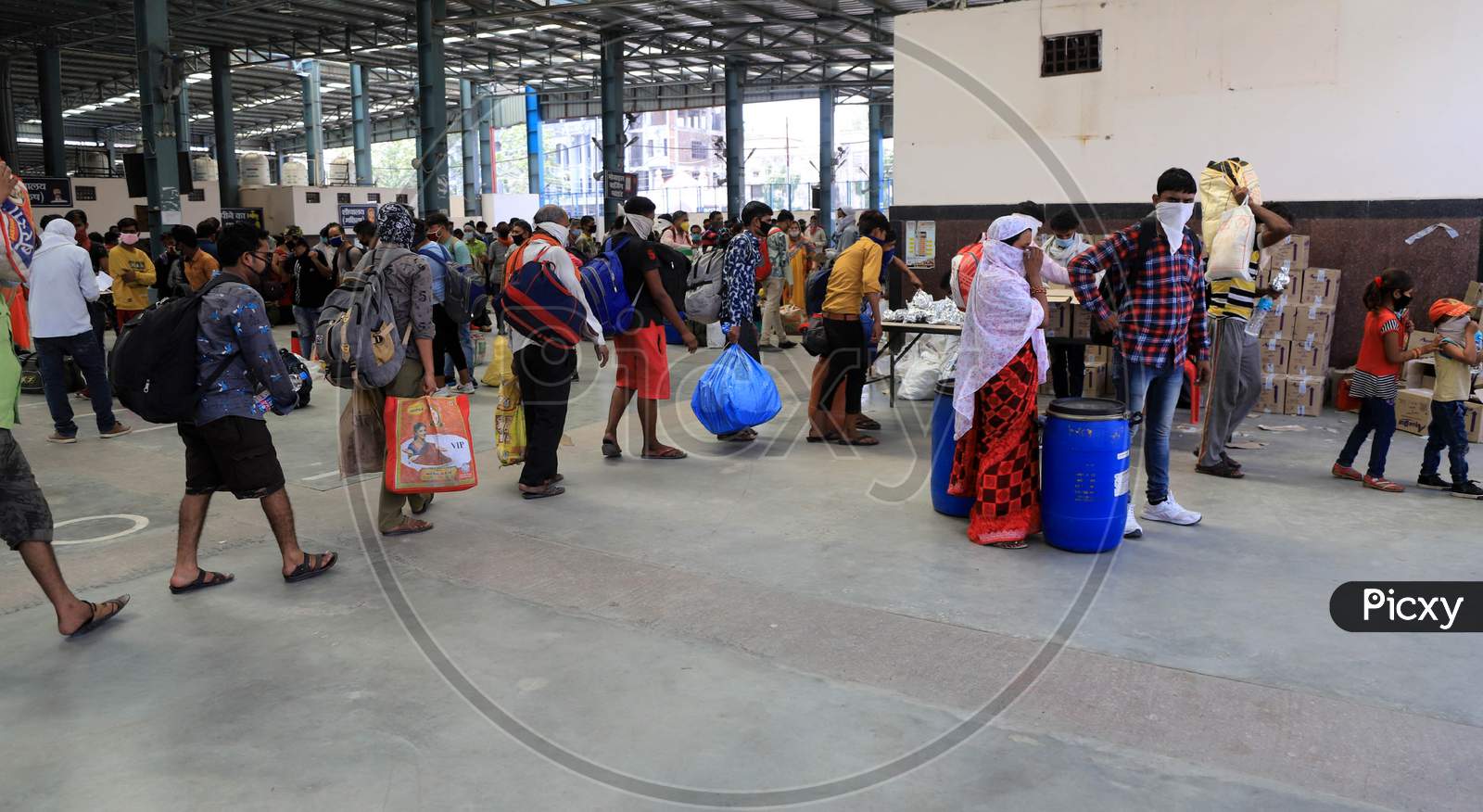 Migrants Takes Food And Water Before Boarding  Buses To Reach Their Native Villages During Extended Nationwide Lockdown Amidst Coronavirus Or COVID-19 Pandemic In Prayagraj, May 25, 2020.