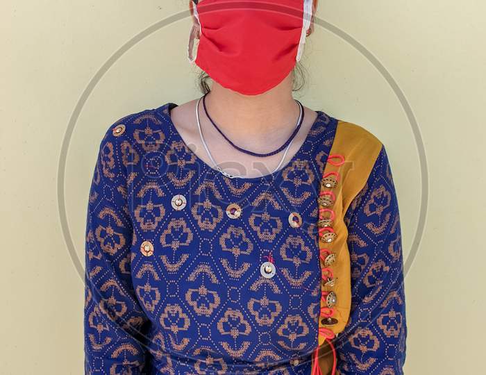 Photo of a young indian girl wearing face mask for prevention from coronavirus during lockdown with selective focus, selective focus on subject, background blur