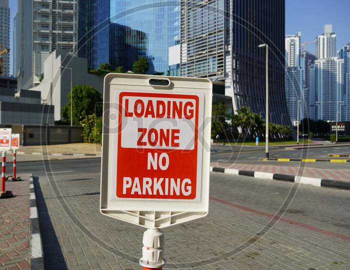 Dubai Uae December 2019 Red And White Sign For No Parking In The Loading Zone Outside A Building. Residential And Commercial Area With No Parking, Loading Zone Sign.