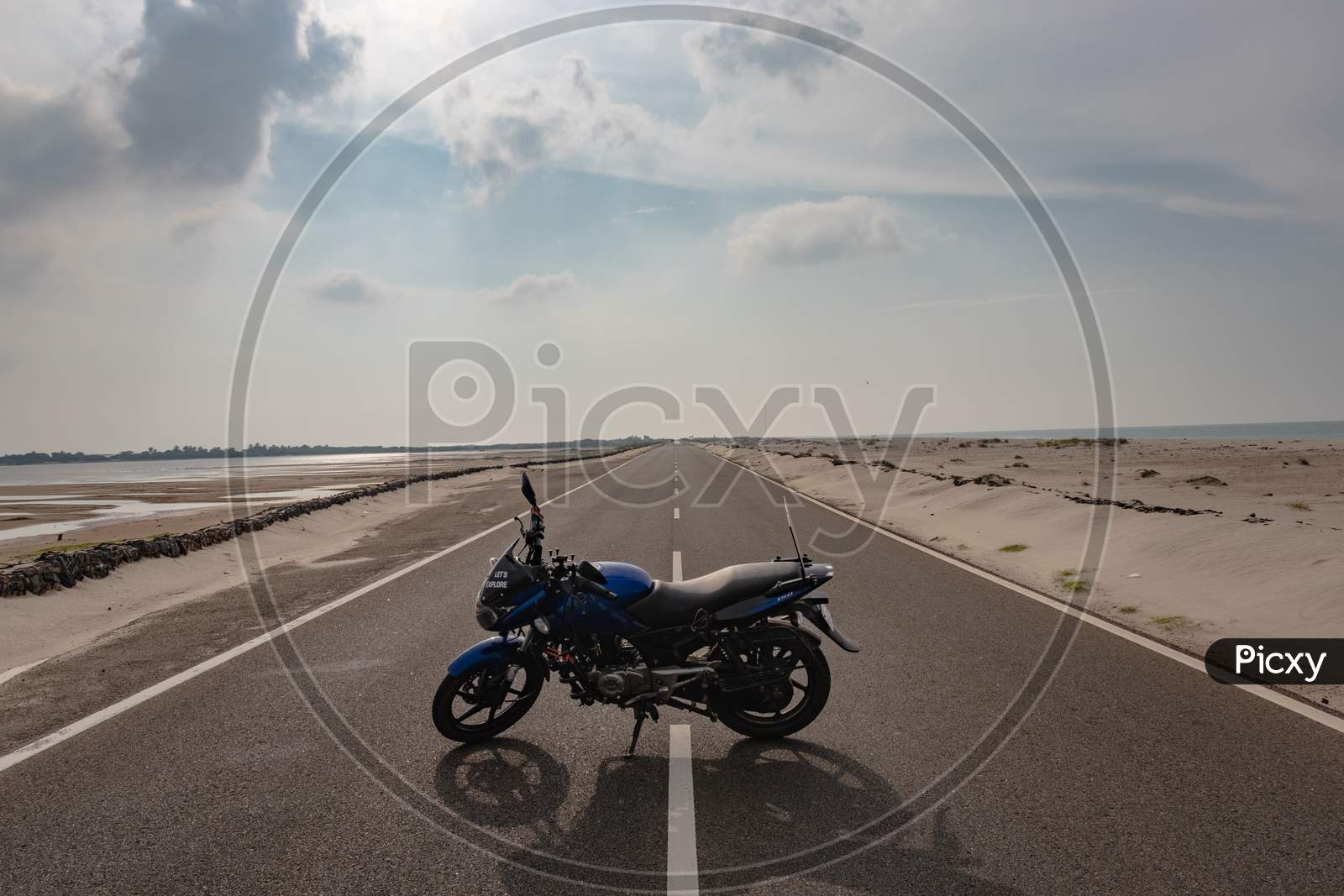 Motorcycle Isolated Standing On Tar Road In Sea Shore Background
