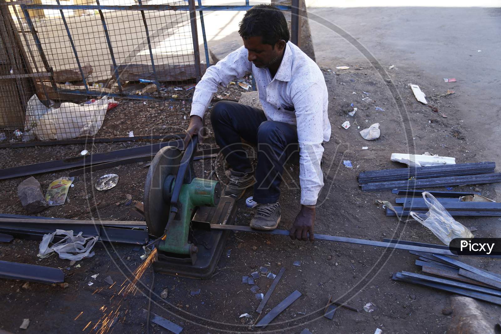 A Worker Cutting Iron Bars With a Machine in Jaisalmer ,Rajasthan, India