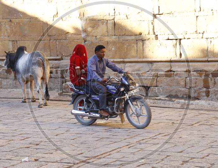 Rajasthani  Husband And Wife Riding On Bike In Jaisalmer, Rajasthan,India