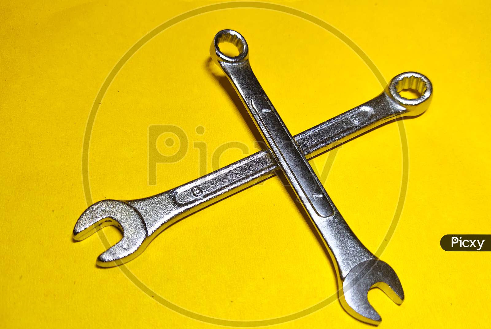 Wrench on the yellow background. working tool