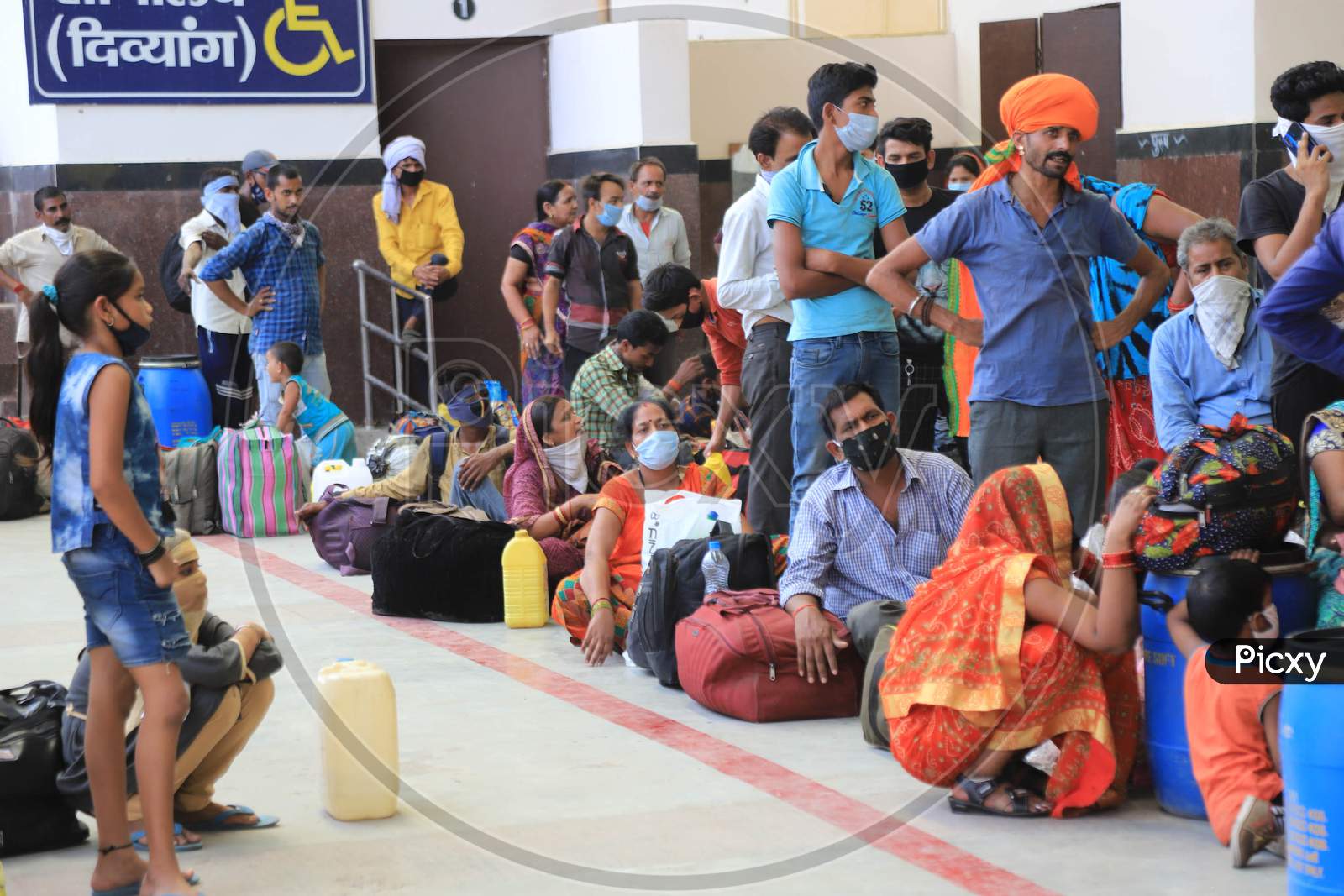 Migrants Arrived By A Special Train Wait To Board Buses For Their Native Villages During Extended Nationwide Lockdown Amidst Coronavirus Or COVID-19 Pandemic In Prayagraj, May 25, 2020.