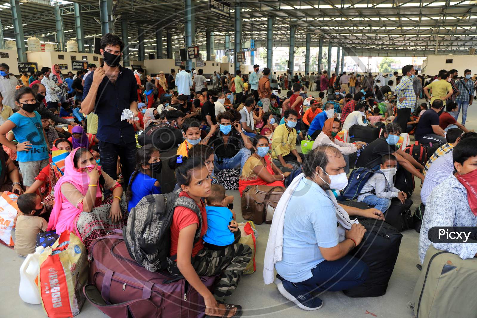 Migrants Who Arrived By A Special Train Wait To Board Buses For Their Native Villages During Extended Nationwide Lockdown Amidst Coronavirus Or COVID-19 Pandemic In Prayagraj, May 25, 2020.