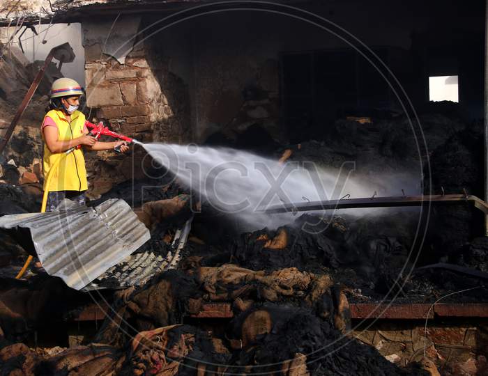 A Firefighter Sprays Water To Control A Fire Broke Out At A Grain Market In Ajmer, Rajasthan, India On 24 May 2020.