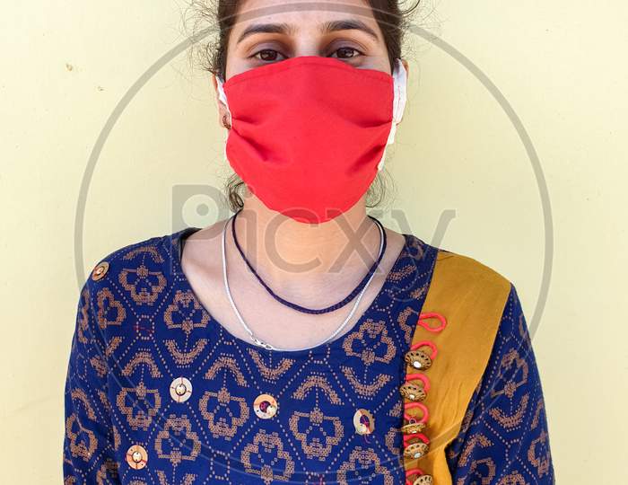 Closeup of a young asian women wearing face mask for prevention from coronavirus during lockdown with selective focus, selective focus on subject, background blur