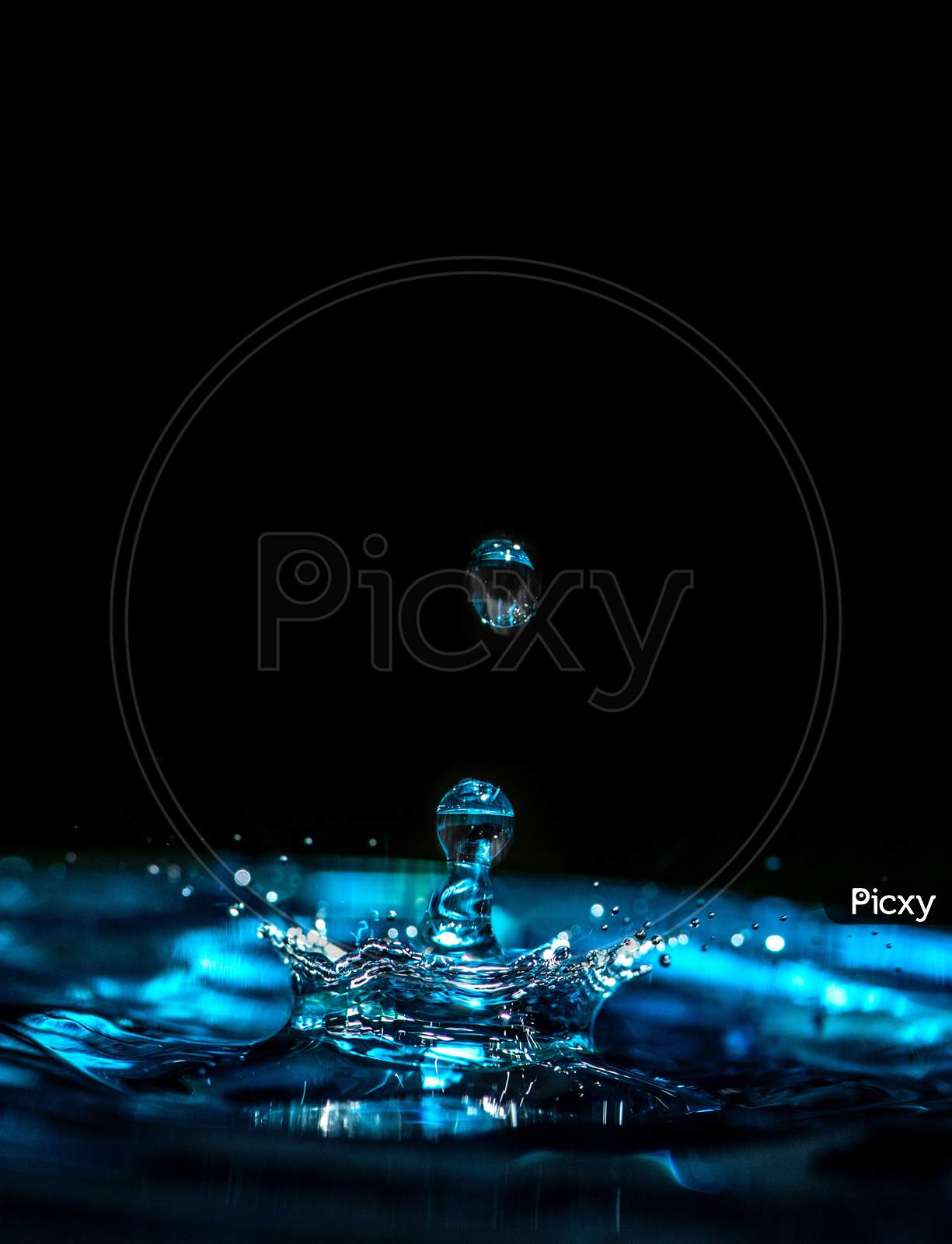 Aqua round water drop photography in dark black background