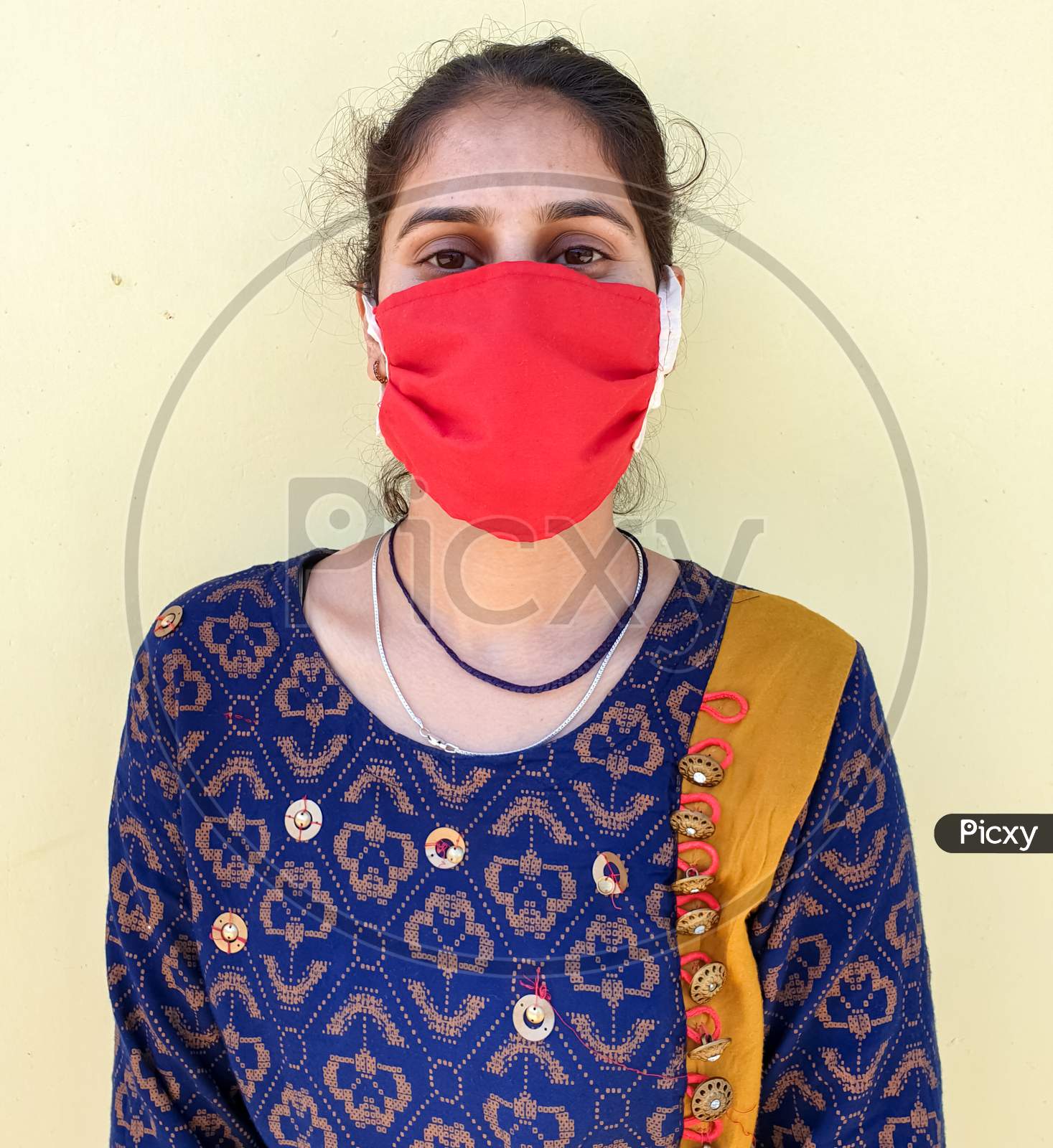 Closeup of a young asian women wearing face mask for prevention from coronavirus during lockdown with selective focus, selective focus on subject, background blur