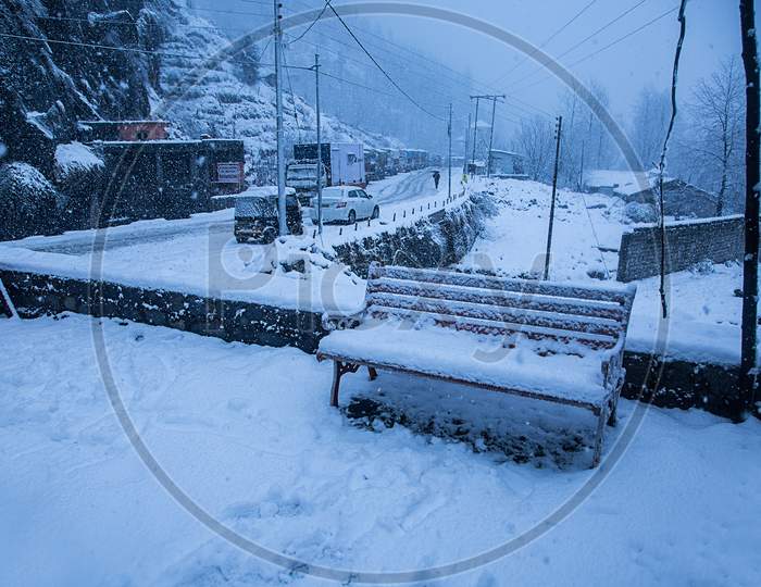 Manali, India - Jan 22, 2019: Park Bench Covered By Heavy Snow. Winters Concept - Image