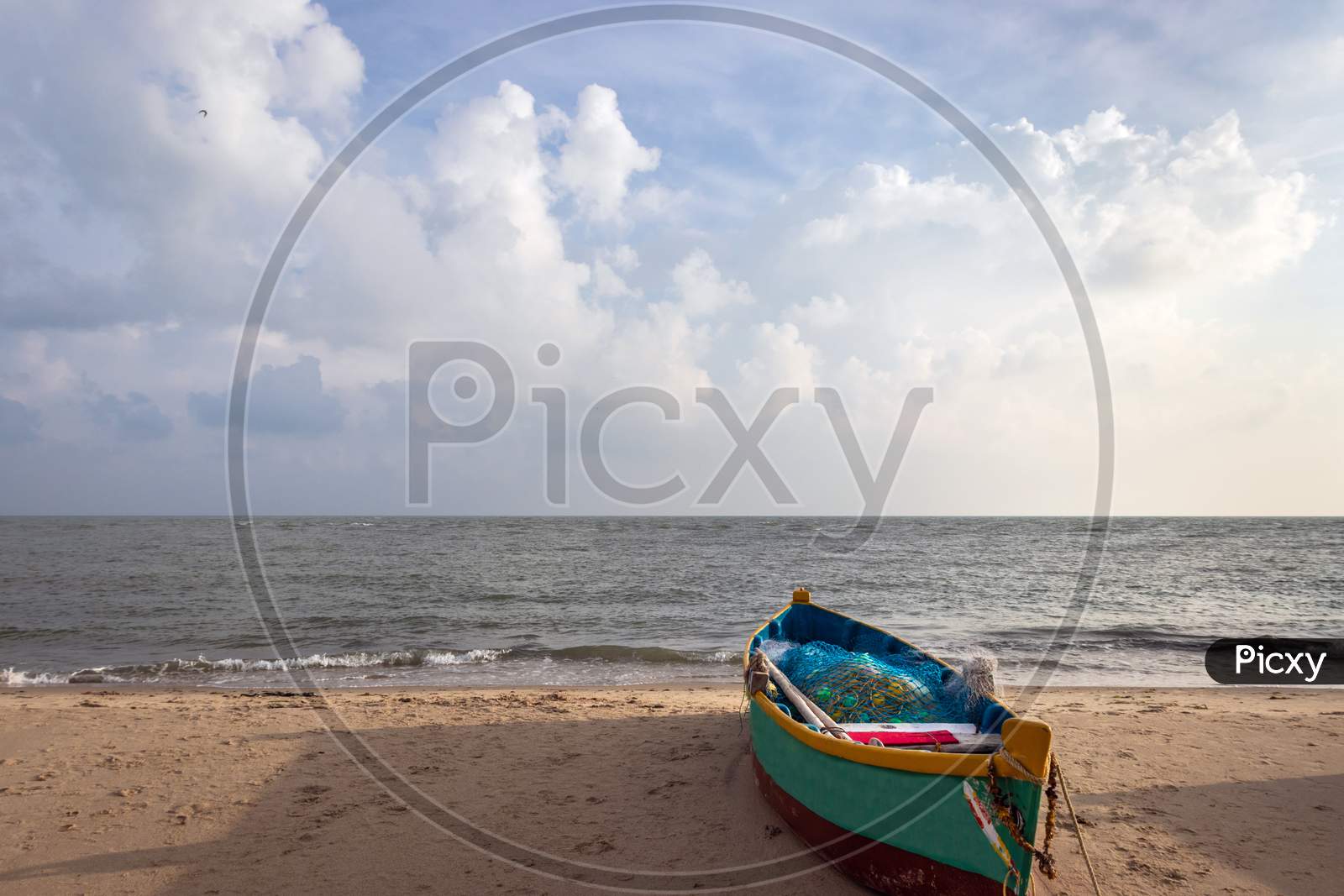Fishing Boat Isolated On The Sandy Beach With Amazing Sky