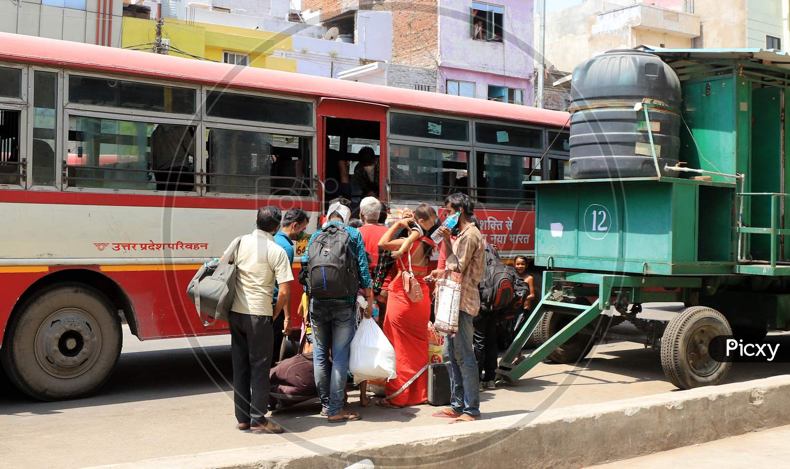 Migrants From Mumbai Arrived By A Special Train Board Buses To Their Native Villages During Extended Nationwide Lockdown Amidst Coronavirus Or COVID-19 Pandemic In Prayagraj, May 25, 2020.