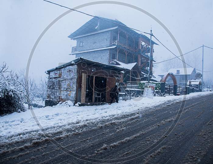 Kashmir, India, January 21, 2019: Snow Covered Houses And Road Just After The Snow Fall Bad Weather Concept