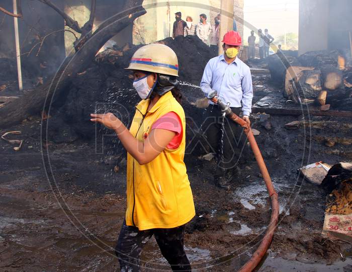 A Firefighter Sprays Water To Control A Fire That Broke Out At A Grain Market In Ajmer, Rajasthan, India On 24 May 2020