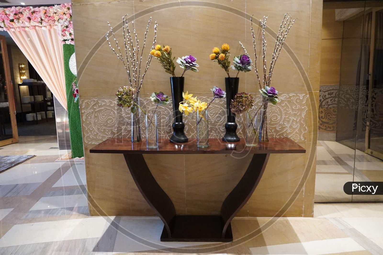 Black And Glass Vases With Flowers Inside Are Put On The Antique Table For Interior Decoration In A Hotel Lobby. They’Re Decorative Items For Vintage Classic Design In House, Hotel, Restaurant.