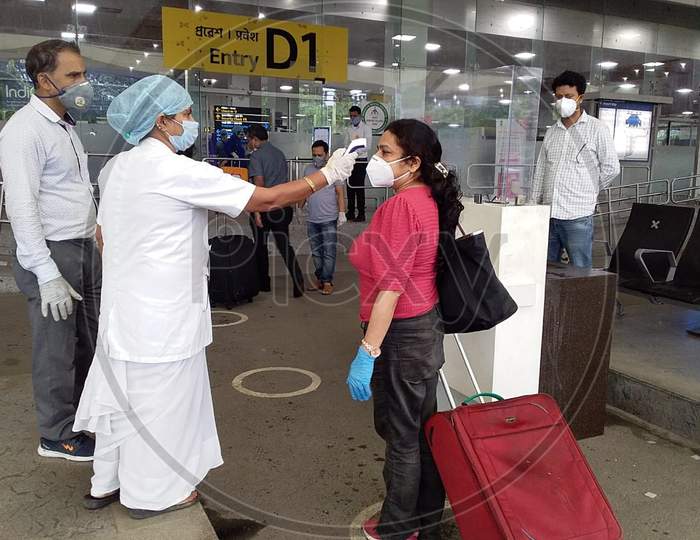 A Passenger Gets Thermal Screening As She Arrives At Lokpriya Gopinath Bordoloi International Airport, Following The Resumption Of Domestic Flights, In Guwahati, Monday, May 25, 2020.