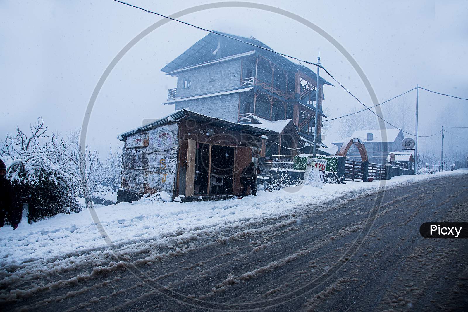 Kashmir, India, January 21, 2019: Snow Covered Houses And Road Just After The Snow Fall Bad Weather Concept