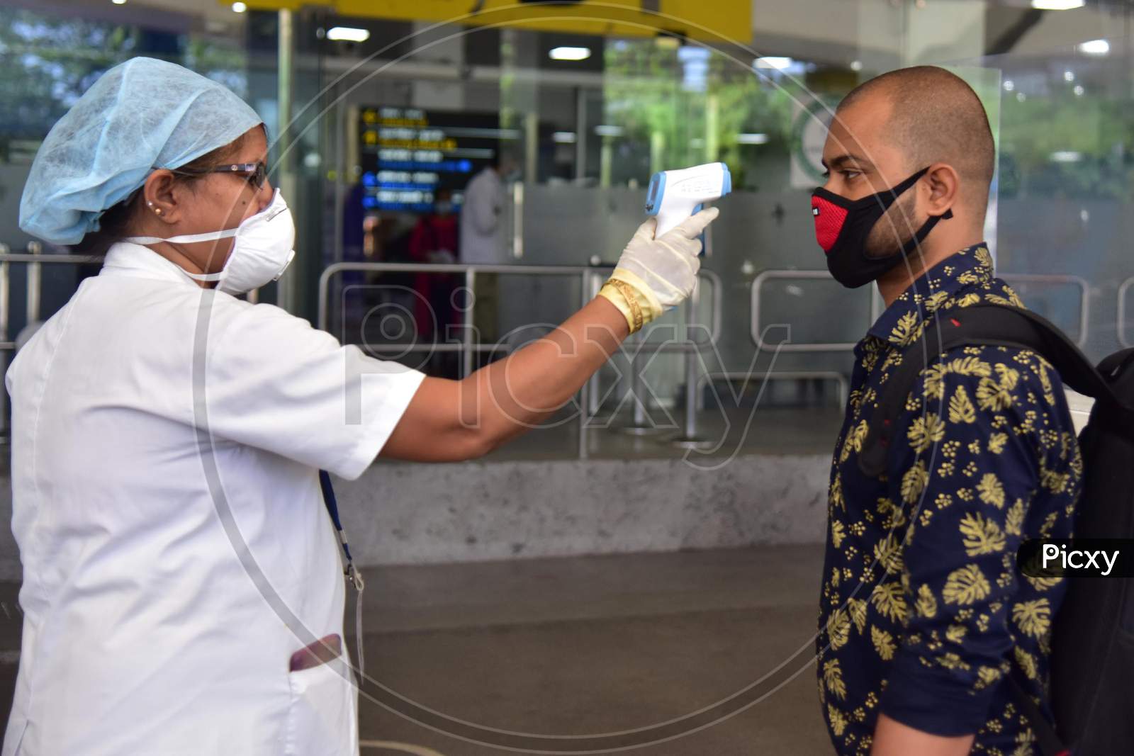 A Passenger Gets Thermal Screening As he Arrives At Lokpriya Gopinath Bordoloi International Airport, Following The Resumption Of Domestic Flights, In Guwahati On May 26,2020.