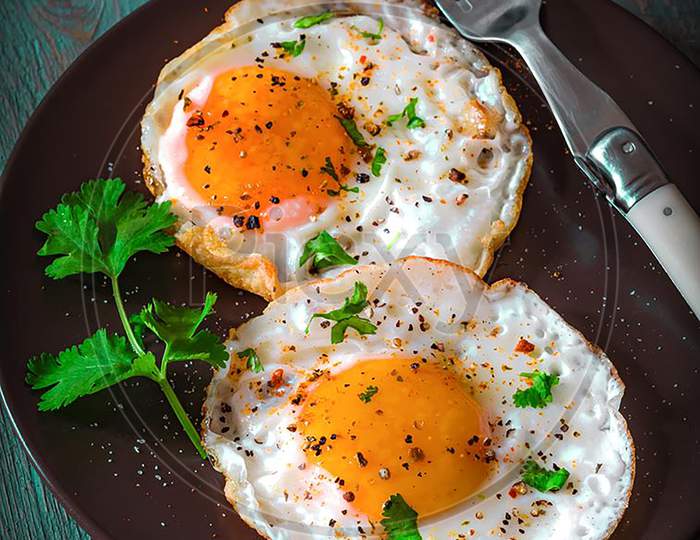 Poached Egg Garnish With Coriander Leaves And Spices