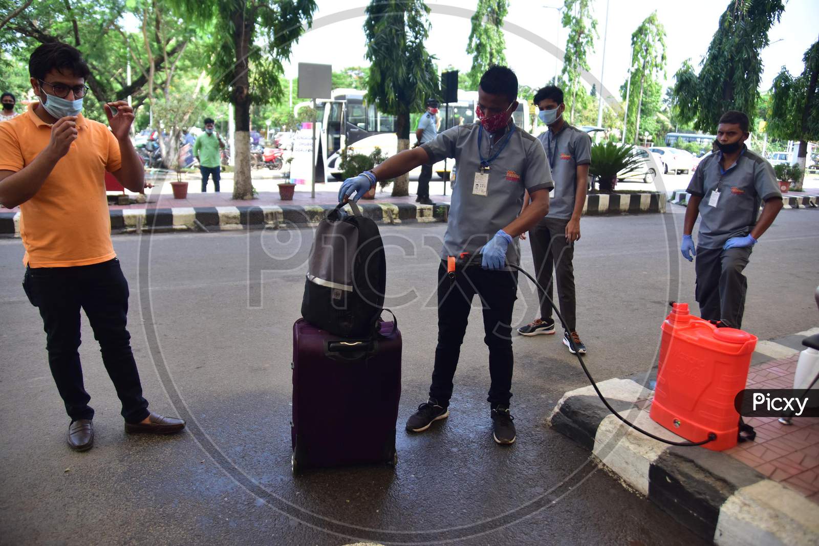 A Worker Sanitizing A Bag Of Passenger  Outsie  Lokpriya Gopinath Bordoloi International Airport, Following The Resumption Of Domestic Flights, In Guwahati On May 26,2020.