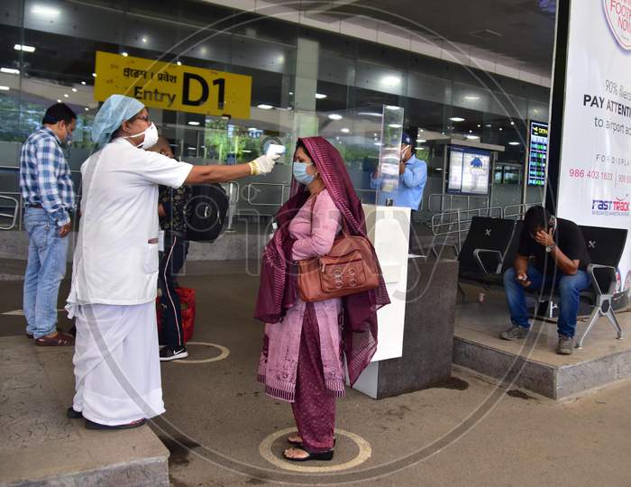 A Passenger Gets Thermal Screening As She Arrives At Lokpriya Gopinath Bordoloi International Airport, Following The Resumption Of Domestic Flights, In Guwahati On May 26,2020.