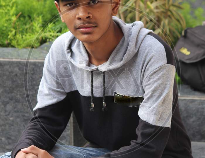 Teenager posing for photo looking at the camera