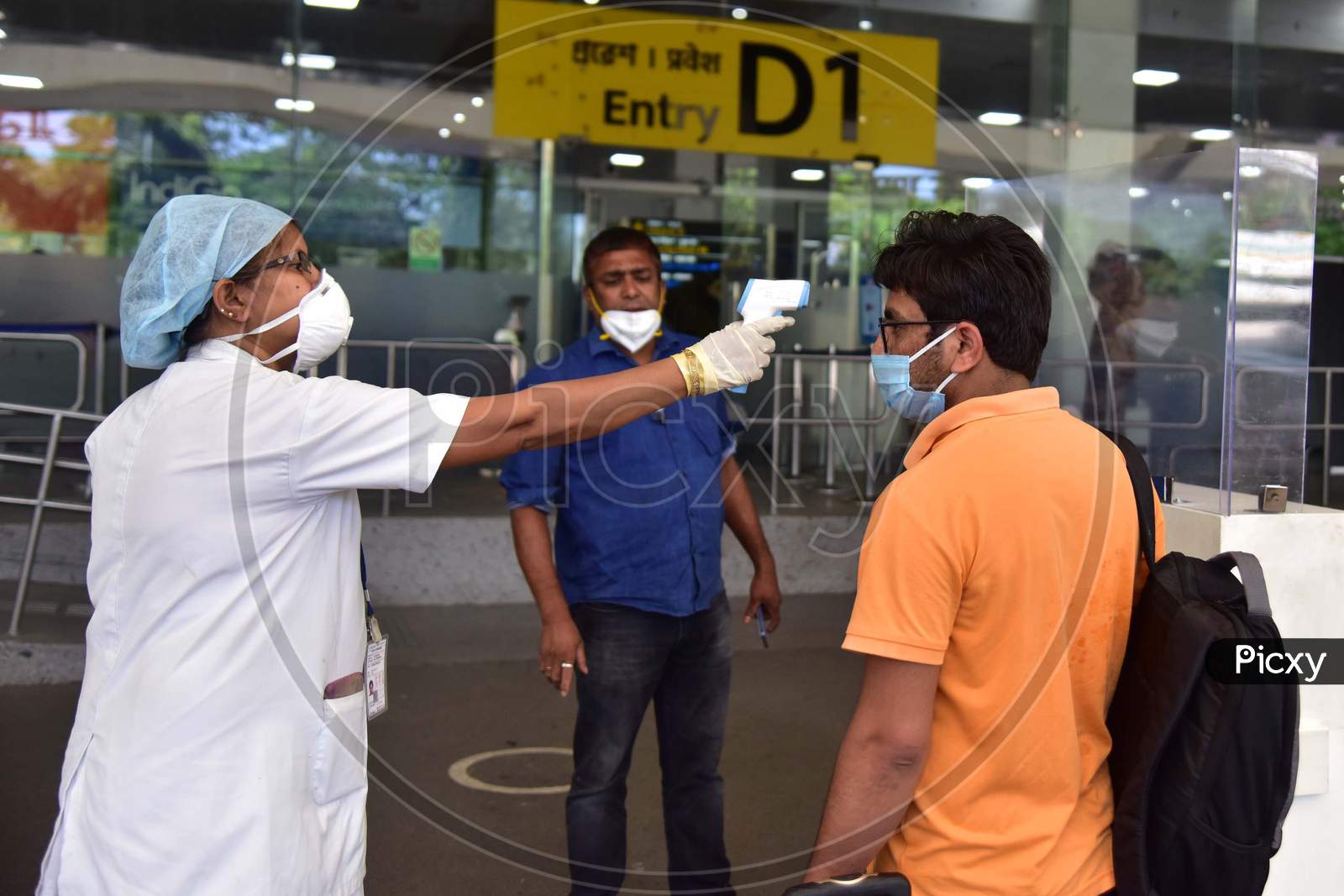 A Passenger Gets Thermal Screening As he Arrives At Lokpriya Gopinath Bordoloi International Airport, Following The Resumption Of Domestic Flights, In Guwahati On May 26,2020.