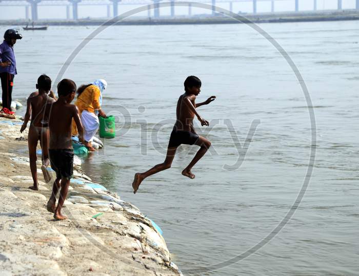 A Boy Jumps In The River Ganga To Beat The Heat On A Hot Summer Day During A Nationwide Lockdown amidst Coronavirus Disease (Covid-19), In Prayagraj, May 26, 2020.