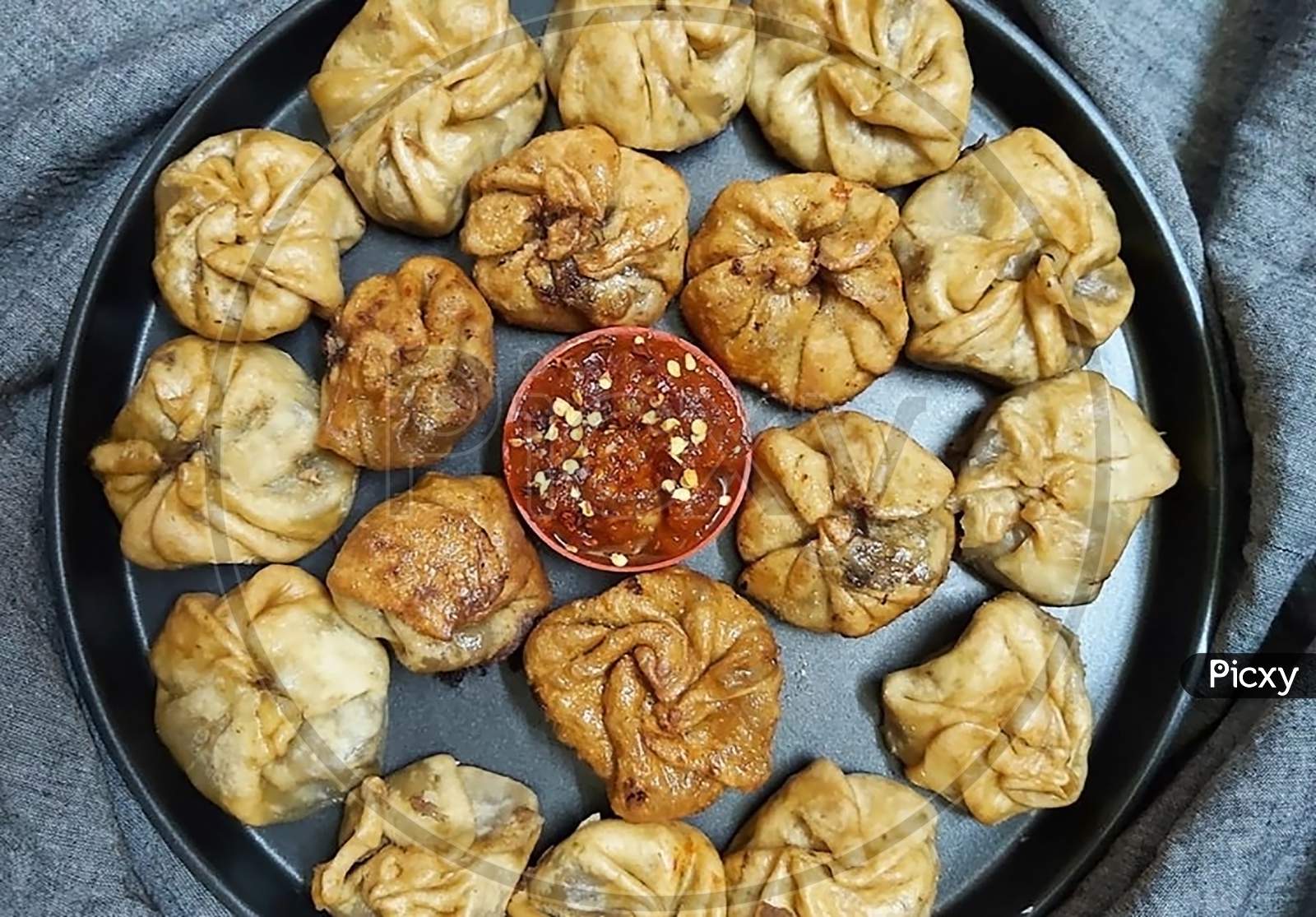 Fried Chicken Momos Garnish With Tomato Pickle