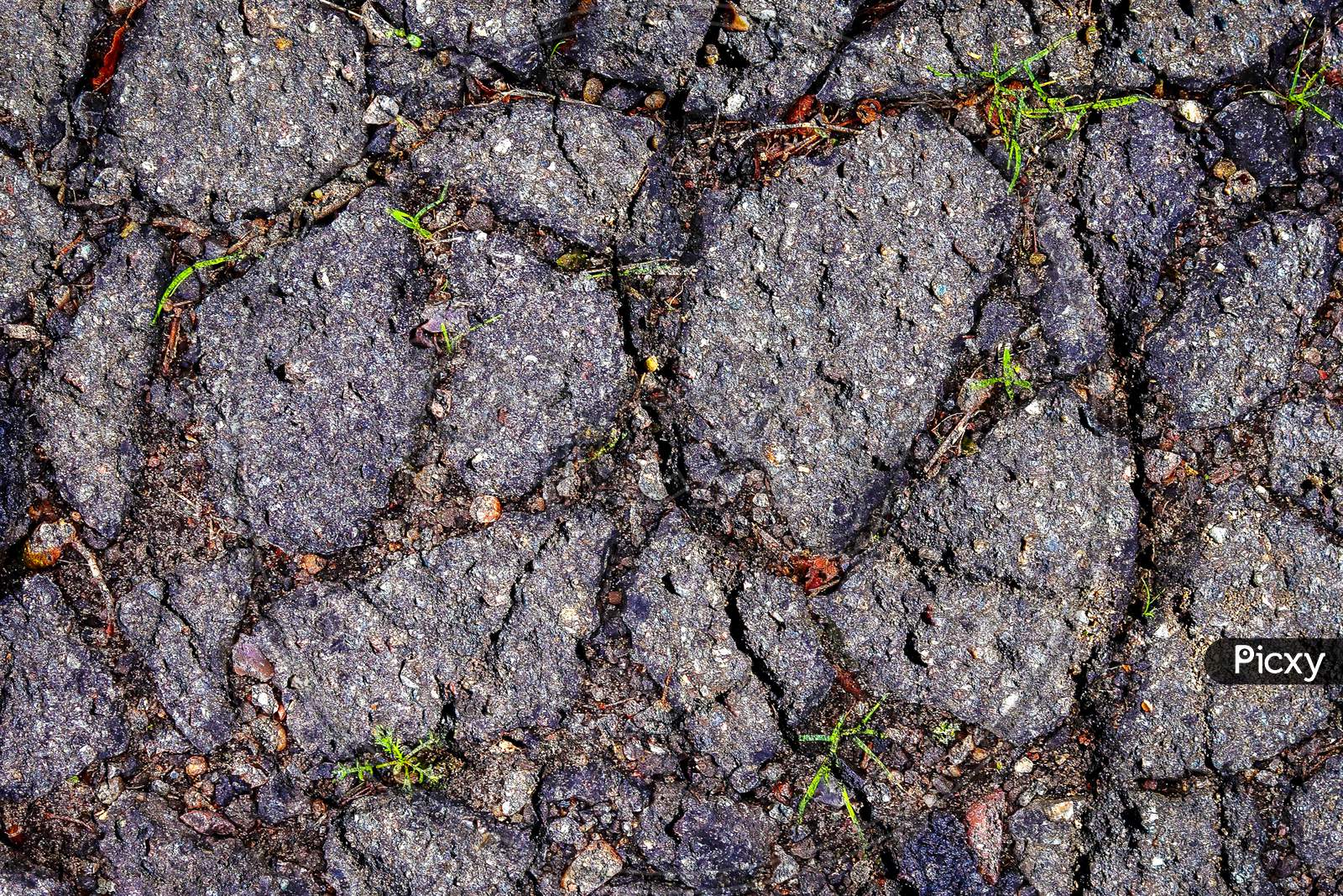 Aged and broken asphalt textures of old european roads and streets