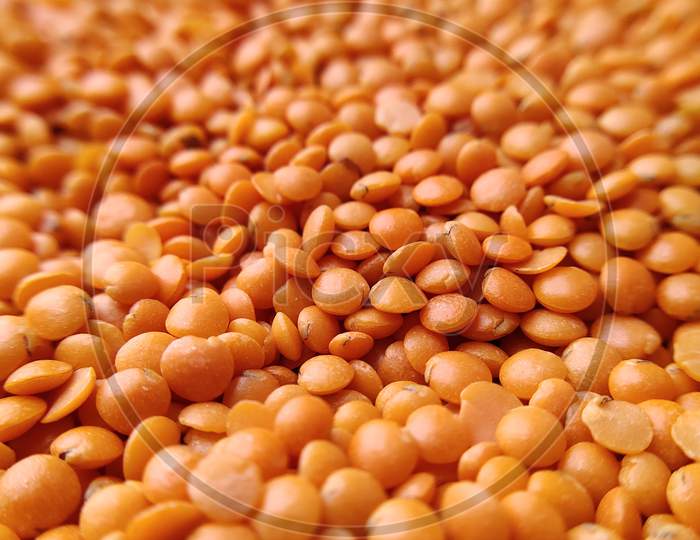 Orange lentils (masoor dal) background, texture