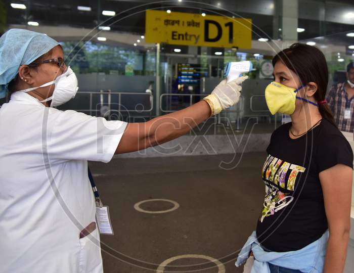 A Passenger Gets Thermal Screening As She Arrives At Lokpriya Gopinath Bordoloi International Airport, Following The Resumption Of Domestic Flights, In Guwahati On May 26,2020..