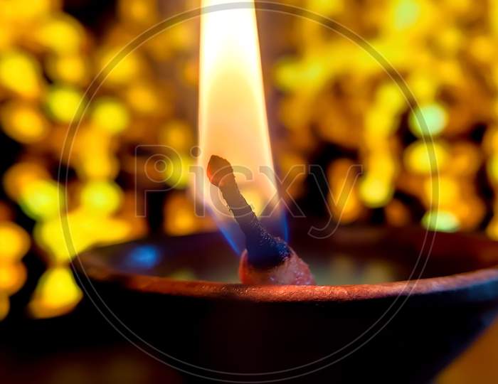 Diya oil lamp lit during Diwali celebration