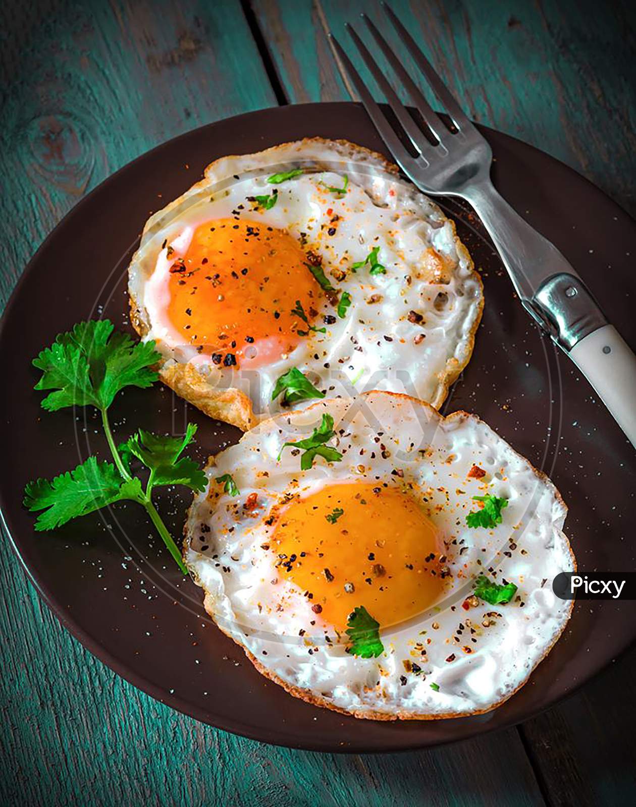 Poached Egg Garnish With Coriander Leaves And Spices