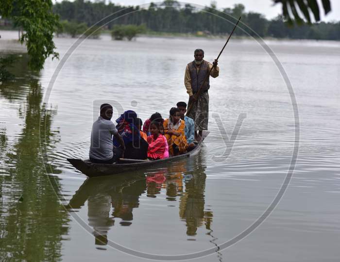 Villagers Are Transported On A Boat Towards A Safer Place  At Flood Affected Bakulguri Village Near Kampur In Nagaon District Of Assam On May 27,2020.