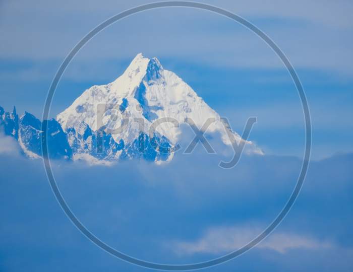 Hill top of Tiger hill or Himalaya mountain cover snow and surrounded by clouds in foggy morning