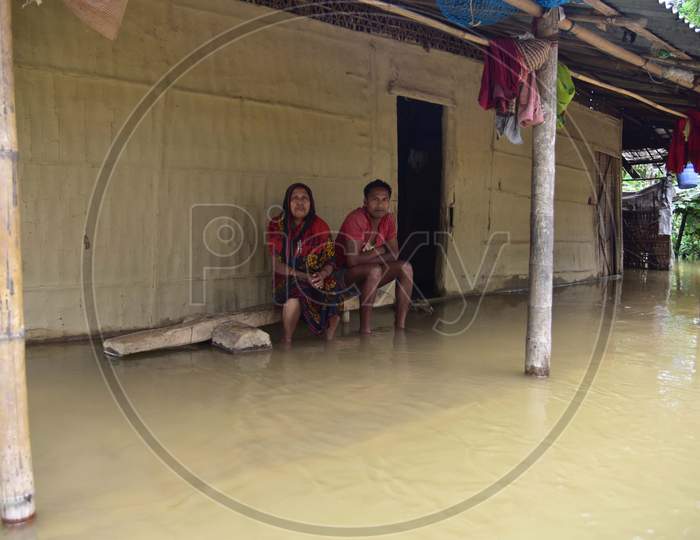A Family sit  Inside their Submerged House At Flood Affected Bakulguri Village Near Kampur In Nagaon District Of Assam On May 27,2020.