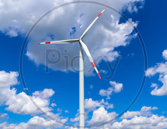 View on alternative energy windmills in a windpark in front of a blue sky