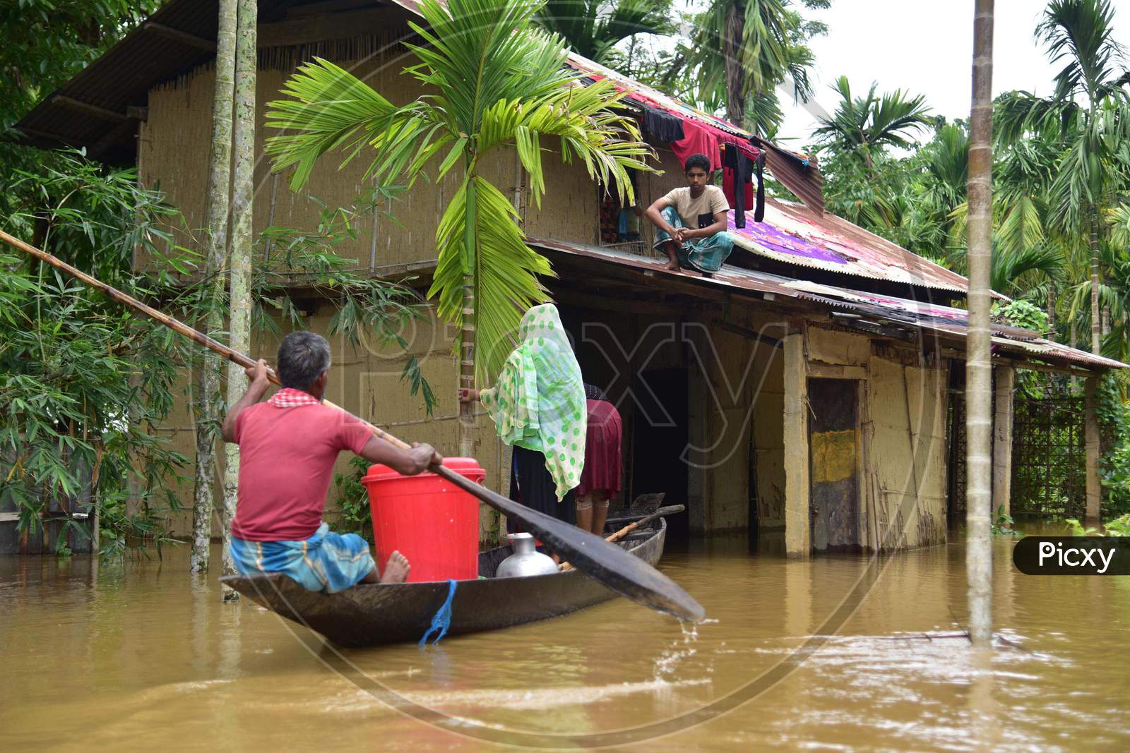 Villagers Are Transported On A Boat Towards A Safer Place  At Flood Affected Bakulguri Village Near Kampur In Nagaon District Of Assam On May 27,2020
