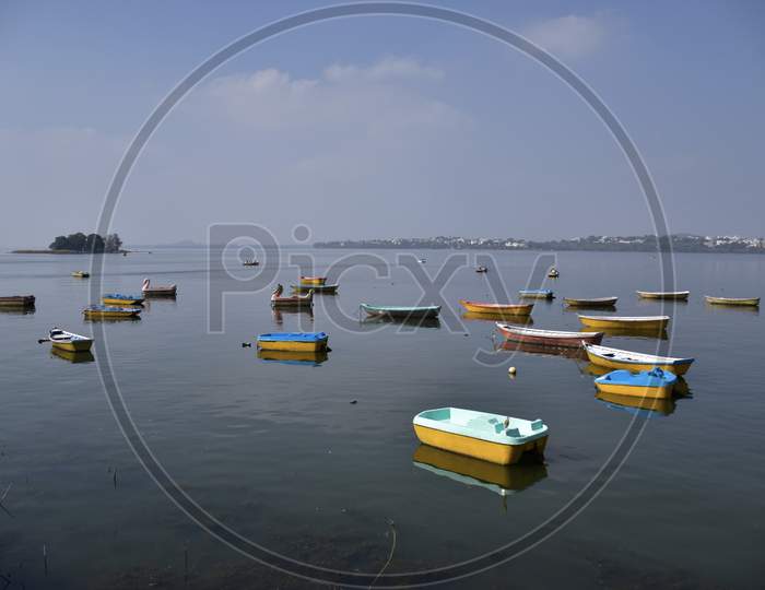 Small Multi color Boats Sailing In The Lake, Bhopal