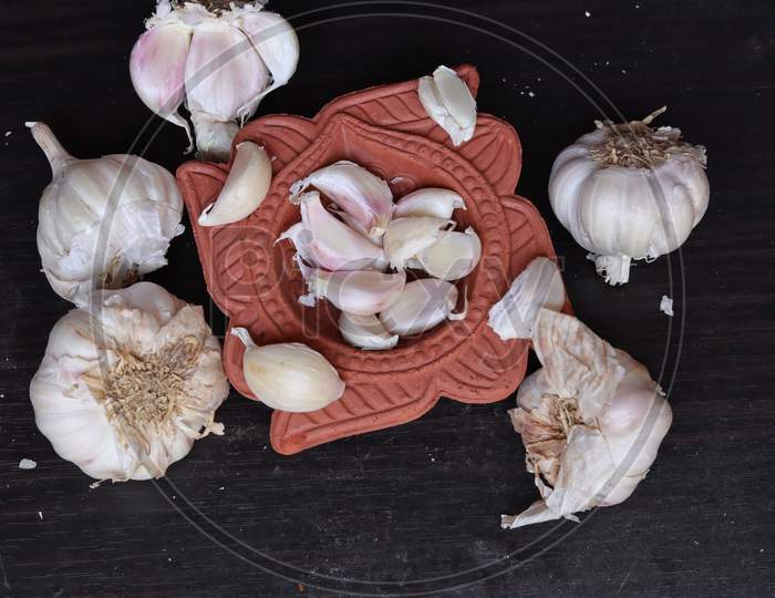 One whole aromatic white garlic isolated on black background