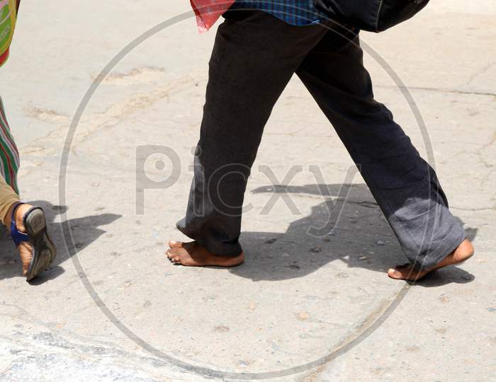 A Migrant walks Naked Feet On The Road On A Hot Day During extended Nationwide Lockdown amidst  Coronavirus or COVID-19 Pandemic  In Prayagraj, May 27, 2020.