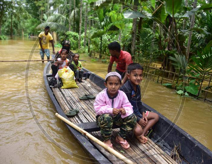 Flood Affected Villagers Arrive At A Safer Place On A Country Boat At  Bakulguri Village Near Kampur In Nagaon District Of Assam On May 27,2020.
