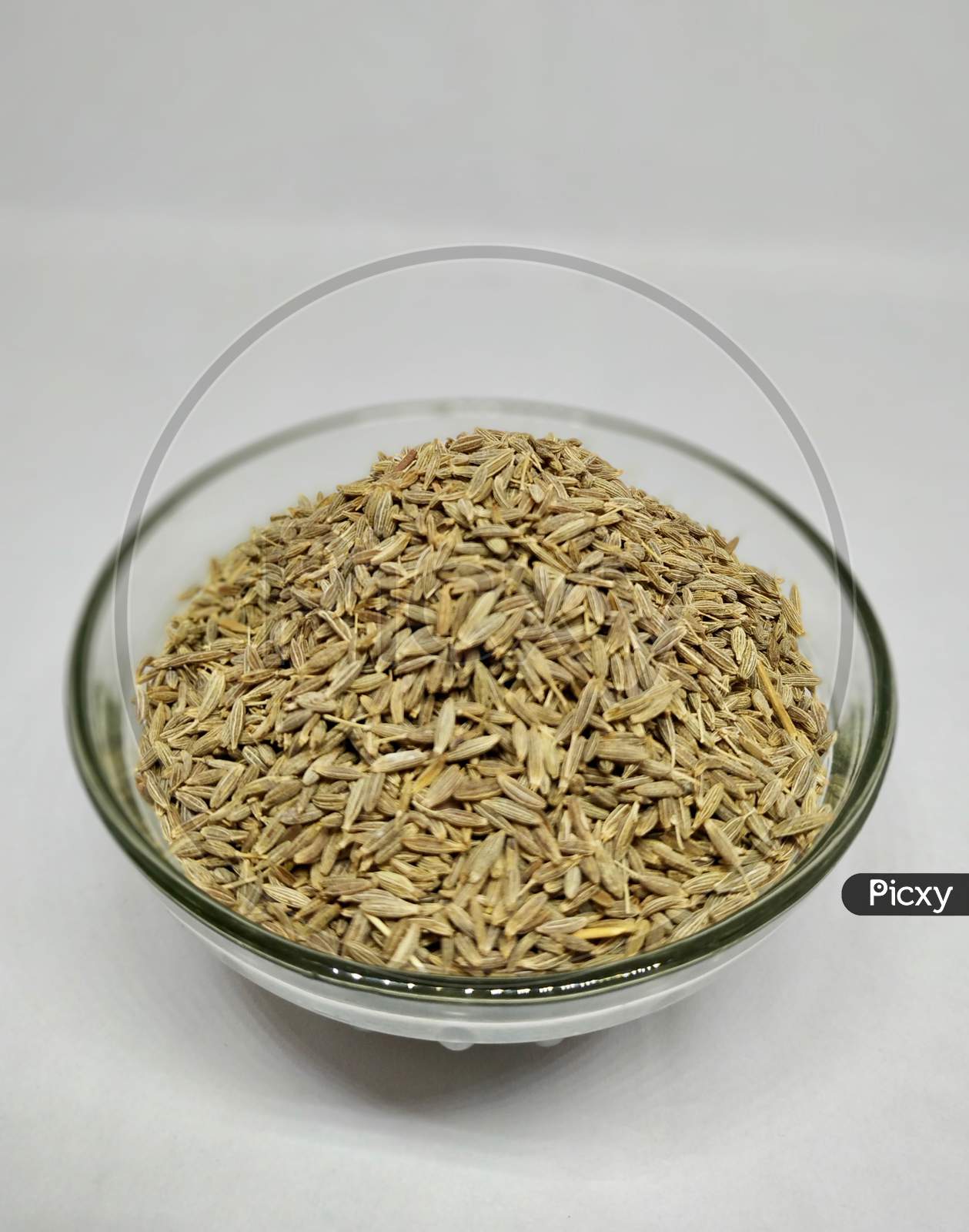 Cumin Or Zeera In A Glass Bowl On White Background Stock Photo